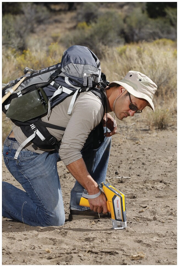 Researcher using Niton XRF Analyzer for soil analysis